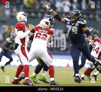 Seattle Seahawks defensive end Red Bryant, right,  pass rushes Arizona Cardinals quarterback John Skelton at CenturyLink Field in Seattle, Washington on  December 9, 2012.  The Seahawks beat the Cardinals 58-0.     UPI/Jim Bryant Stock Photo