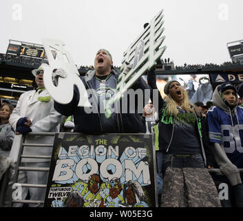 Seattle Seahawks fan Lorin 'Big Lo' Sandretzky, center,  cheers against the Arizona Cardinals at CenturyLink Field in Seattle, Washington on  December 9, 2012.  The Seahawks beat the Cardinals 58-0.     UPI/Jim Bryant Stock Photo