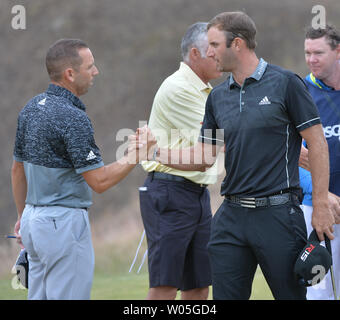 Dustin Johnson (R) shakes hands with Sergio Garcia of Spain after completing round one of the 115th U.S. Open Championship at Chambers Bay on June 18, 2015 in University Place, Washington. Johnson ended the day five under par.    Photo by Kevin Dietsch/UPI Stock Photo