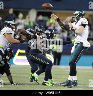 Seattle Seahawks  defensive back DeShawn Shead (35) and defensive tackle Jarran Reed (90) pressures Philadelphia Eagles Quarterback Carson Wentz (11) at CenturyLink Field in Seattle, Washington on November 20, 2016.  Seahawks beat the Eagles 26-15.   Photo by Jim Bryant/UPI Stock Photo