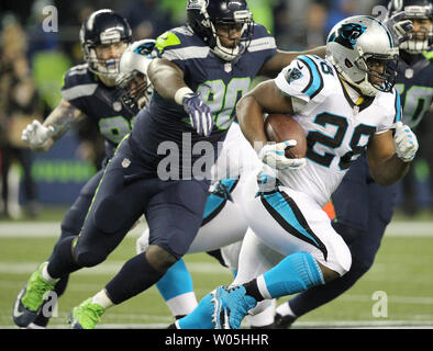 Carolina Panthers running back Jonathan Stewart (28) tries to outrun Seattle Seahawks defensive tackle Jarran Reed (90) at CenturyLink Field in Seattle, Washington on December 4, 2016.  Seahawks beat the Panthers 40-7.   Photo by Jim Bryant/UPI Stock Photo