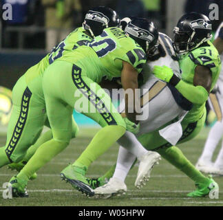 Los Angeles Rams running back Todd Gurley (30) is held to no gain by Seattle Seahawks outside linebacker K.J. Wright (50),  defensive tackle Jarran Reed (90) and strong safety Kam Chancellor (31) during the fourth quarter at CenturyLink Field in Seattle, Washington on December 15, 2016.  The Seahawks beat the Rams 24-3.  Photo by Jim Bryant/UPI Stock Photo