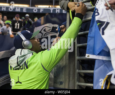 Green Bay, WI, USA. 12th Jan, 2020. Green Bay Packers cornerback Jaire  Alexander #23 rips the shirt of Seattle Seahawks running back Marshawn Lynch  #24 while a host of Packers make the