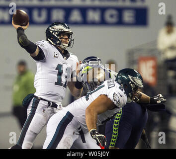 Philadelphia Eagles quarterback Carson Wentz (11) passes under pressure from Seattle Seahawks defensive tackle Jarran Reed (90) during the third quarter at CenturyLink Field in Seattle, Washington on December 3, 2017.  Seattle Seahawks beat Philadelphia Eagles 24-10.    Photo by Jim Bryant/UPI Stock Photo