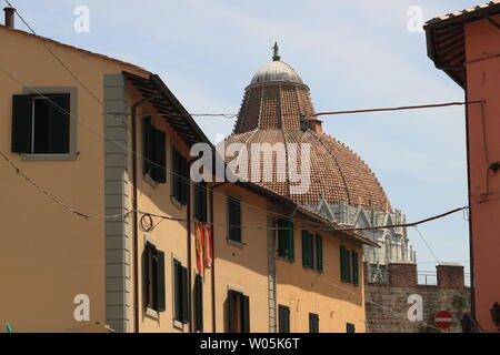 Pisa, Tuscany, Italy. 06/21/2019. Baptistery, walls and typical houses of the city. The dome of one of the buildings in Piazza dei Miracoli and the ci Stock Photo