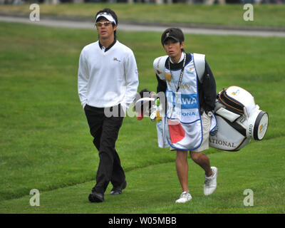 International team member Ryo Ishikawa walks with his caddie Hiroyuki Kato during the third round of The Presidents Cup at Harding Park Golf Course in San Francisco, California on October 10, 2009.    UPI/Kevin Dietsch Stock Photo