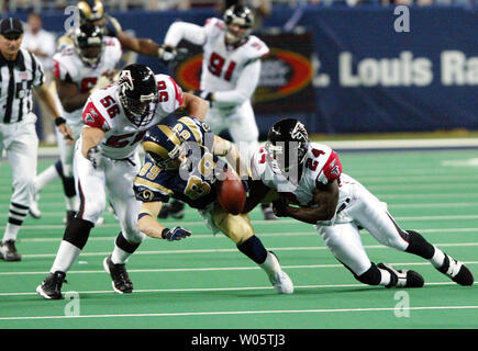 Tampa Bay Buccaneers' wide receiver Joey Galloway (84) is tackled by Atlanta  Falcons' linebacker Keith Brooking (56) during the Bucs 27-0 win in a game  up against the Falcons at Raymond James