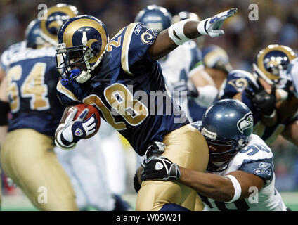 Football Hall of Fame member Marshall Faulk's name is unveiled in the St. Louis  Rams Ring of Honor during the Cincinnati Bengals-St. Louis Rams football  game at the Edward Jones Dome in