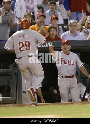Philadelphia Phillies' manager Larry Bowa greets Marlon Byrd as he enters the dugout after sliding safely into homeplate with the teams go-ahead run in the ninth inning against the St. Louis Cardinals at Busch Stadium in St. Louis on April 28, 2004.   (UPI Photo/Bill Greenblatt) Stock Photo