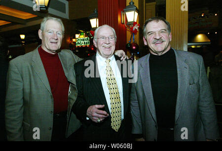 Former St. Louis football Cardinals head coach and St. Louis Rams offensive line coach Jim Hanifan (C) poses with Football Hall of Famers Jackie Smith (L) and Dan Dierdorf before the start of a celebrity roast for Hanifan at the Ameristar Casino in St. Charles, Mo on December 13, 2004. Hanifan has been a football coach on the high school, college and professional levels since 1959. (UPI Photo/Bill Greenblatt) Stock Photo