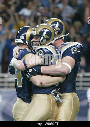 St. Louis Rams Dane Looker (C) and Cam Cleeland (R) celebrate with place kicker Jeff Wilkins after Wilkins kicks the game winning field goal against the New York Jets in overtime at the Edward Jones Dome  in St. Louis on January 2, 2004.St. Louis won the game 32-29.  (UPI Photo/Bill Greenblatt) Stock Photo