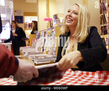 Playboy's Miss March, Jillian Grace holds a copy of the magazine that