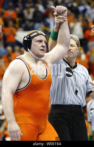 Heavyweight wrestler Steve Mocco of Oklahoma State is declared the winner over Minnesota's Cole Konrad in the 2005 NCAA Division 1 Wrestling Championships at the Savvis Center in St. Louis, on March 19, 2005. The match went into an overtime period with Mocco coming out on top with a takedown resulting in a score of 3-1.  (UPI Photo/Bill Greenblatt) Stock Photo