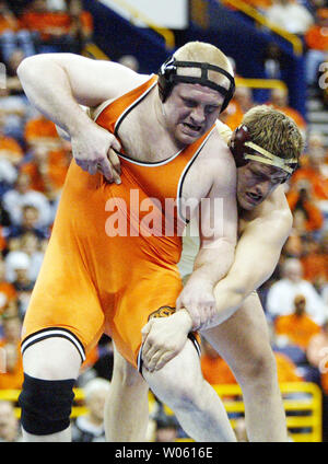 Heavyweight wrestler Steve Mocco of Oklahoma State  (L) fights off a takedown attempt by Minnesota's Cole Konrad in the 2005 NCAA Division 1 Wrestling Championships at the Savvis Center in St. Louis, on March 19, 2005. The match went into an overtime period with Mocco coming out on top with a takedown resulting in a score of 3-1.  (UPI Photo/Bill Greenblatt) Stock Photo