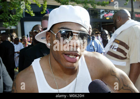 Rapper Nelly stops to do a television interview as he walks down the red carpet during a movie premier for the Longest Yard in University City, Mo on May 22, 2005. Nelly, a St. Louis native, plays the part of a football player on a prison team in the remake of the 70's film. (UPI Photo/Bill Greenblatt) Stock Photo