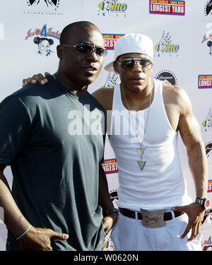 Rapper Nelly (R) poses for a photograph with St. Louis Rams Marshall Faulk as he walks down the red carpet during a movie premier for the Longest Yard in University City, MO on May 22, 2005. Nelly, a St. Louis native, plays the part of a football player on a prison team. (UPI Photo/Bill Greenblatt) Stock Photo