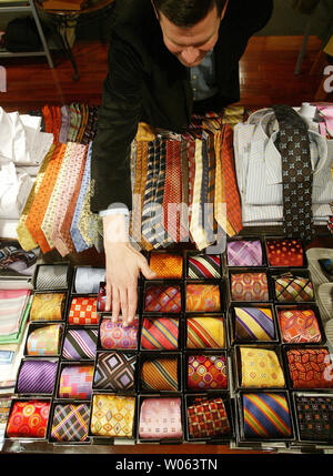 Salesman Doug Winship adjusts a colorful tie  display at Mister Guy Clothier in Ladue, MO on November 25, 2005. Shoppers turned out in full force nationwide as the  Christmas shopping season begins.   (UPI Photo/Bill Greenblatt) Stock Photo