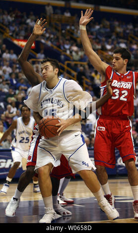 Saint Louis University Billikens Ian Vouyoukas (15) moves toward the basket past the defense of Dayton Flyers Chris Alvarez (32) and Charles Little (hidden) at Savvis Center in St. Louis on March 1, 2006. (UPI Photo/Bill Greenblatt) Stock Photo