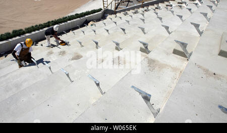 Construction workers install the brackets that will hold the seats in left centerfield at the new Busch Stadium in St. Louis on March 16, 2006. The Cardinals will play their first game in the new facility on April 10. (UPI Photo/Bill Greenblatt) Stock Photo