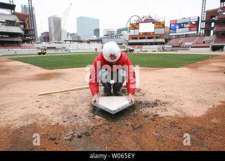Head groundskeeper Bill Finley installs the homeplate at the new Busch Stadium in St. Louis on March 17, 2006. The homeplate is the same one used at the old Busch Stadium which the Cardinals played in for nearly 40 years. The St. Louis Cardinals will play their first game in the new facility on April 10. (UPI Photo/Bill Greenblatt) Stock Photo