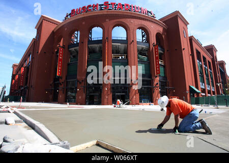 Construction worker Bill Swan applies the finishing touches to concrete work on the sidewalk in the leftfield area outside of Busch Stadium on June 5, 2006. Most of all the construction on the new ballpark is complete except this area which will contain the Cardinals offices. (UPI Photo/Bill Greenblatt) Stock Photo