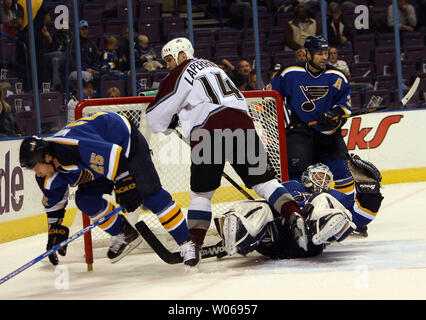 St. Louis Blues' Ian Laperriere (22) drives toward the net as he is checked  by San Jose Sharks' Jeff Friesen in the first period, Thursday, Nov. 16,  1995, at the Kiel Center