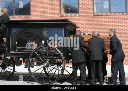 Pallbearers place the casket of Denver Broncos running back Damien Nash into a old carriage for the three mile trip to a nearby cemetery in St .Louis on March 5, 2007. Nash, 24, died on February 24, after playing in a charity basketball game. (UPI Photo/Bill Greenblatt) Stock Photo