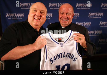 Former Utah head basketball coach and ESPN college basketball analyst Rick Majerus (L) holds a jersey with Saint Louis University President Lawrence Biondi after Majerus is introduced as the new head basketball coach at the school in St. Louis on April 30, 2007.   (UPI Photo/Bill Greenblatt) Stock Photo