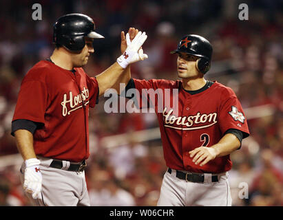 Houston Astros' Chris Burke (2) is congratulated by teammate Lance