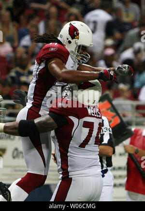 Arizona Cardinals Larry Fitzgerald (L) jumps into the arms of teammate Reggie Wells after Fitzgerald caught a late fourth quarter touchdown pass against the St. Louis Rams at the Edward Jones Dome in St. Louis on October 7, 2007. Arizona won the game 34-31. (UPI Photo/Bill Greenblatt) Stock Photo