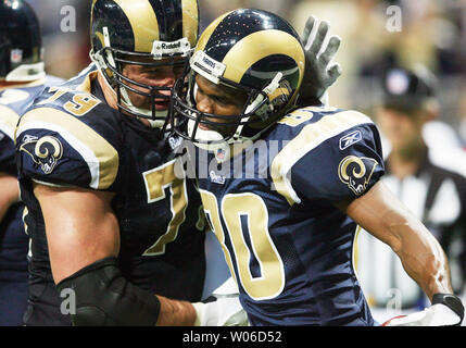 Former St. Louis Rams Isaac Bruce holds the Super Bowl trophy during  ceremonies celebrating the teams Super Bowl victory in the 1999-2000  season, at the Edward Jones Dome during half time of