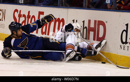 St. Louis Blues Jay McKee (L) pushes Chicago Blackhawks Jassen Cullimore  off of the puck in the first period at the Scottrade Center in St. Louis on  January 4, 2007. (UPI Photo/Bill