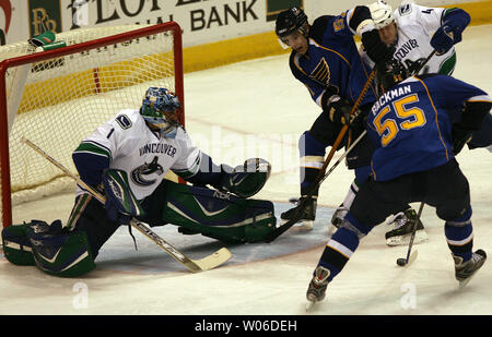 St. Louis Blues Christian Backman (55) comes over the shoulder of Detroit Red  Wings Brendan Shanahan as the two go after the puck in the first period at  the Savvis Center in