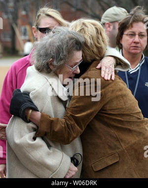 Family members of a dead Kirkwood police officer hug outside of the Police Department headquarters in Kirkwood, Missouri on February 8, 2008. Five people were shot dead and two injured when a gunman burst into a city hall meeting and begun shooting on February 7. Two other injuries included the mayor who was shot in the head and a newspaper reporter who was shot in the hand. Police shot and killed the gunman.       (UPI Photo/Bill Greenblatt) Stock Photo