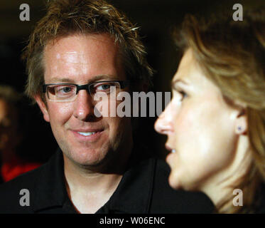 Funny Car driver Tommy Johnson, Jr. listens as wife, fellow funny car  driver Melanie Troxel, talks with reporters in St. Louis on May 1, 2008.  The two, from Indianapolis, are St. Louis for the O'Riley NHRA Midwest  Nationals at Gateway International Raceway ...