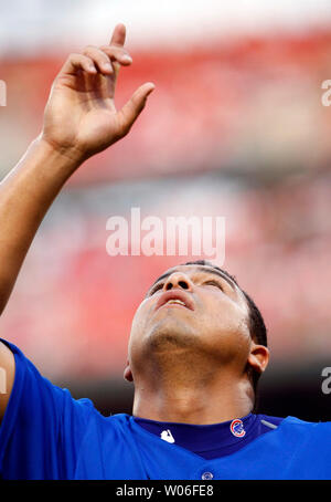 Chicago Cubs' Carlos Zambrano points to the sky as he crosses home plate  after hitting a home run during the fourth inning of a baseball game  against the Cincinnati Reds, Friday, April