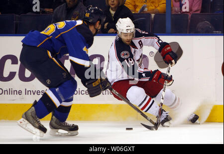 Columbus Blue Jackets center Michael Peca (19) checks Buffalo