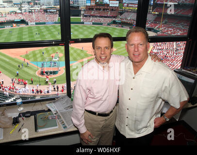 Chicago Cubs broadcasters Ron Santo (L) and Pat Hughes pose for a  photograph in the broadcast booth before a game against the St. Louis  Cardinals at Busch Stadium in St. Louis on