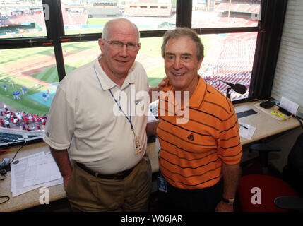 Chicago Cubs broadcasters Ron Santo (L) and Pat Hughes pose for a  photograph in the broadcast booth before a game against the St. Louis  Cardinals at Busch Stadium in St. Louis on