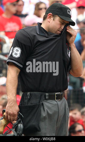 Home plate umpire Chris Guccione tries to get some relief by wiping his face with his shirt during a game between the Kansas City Royals and the St. Louis Cardinals at Busch Stadium in St. Louis on May 23, 2009. Temperatures climbed into the upper 80's as St. Louis defeated Kansas City 5-0. (UPI Photo/Bill Greenblatt) Stock Photo