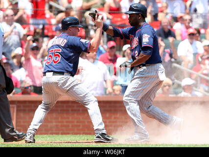 Minnesota Twins third baseman Nick Punto #8 slides into third base on a  single by Denard Span #2 in the 2nd inning of the Twins' baseball game  against the Chicago White Sox