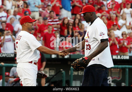 St. Louis Cardinals slugger Albert Pujols (L) talks with NBA star Shaquille  O'Neal while visiting batting practice at Busch Stadium in St. Louis on  August 11, 2009. Shaquille O'Neal is in St.