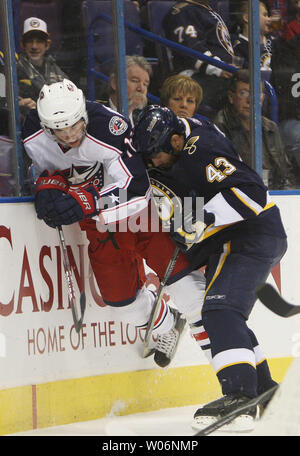 St. Louis Blues Mike Weaver (43) checks Columbus Blue Jackets Derick Brassard hard into the boards  in the first period at the Scottrade Center in St. Louis on January 30, 2010.    UPI/Bill Greenblatt Stock Photo