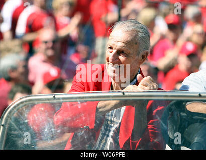 Former St. Louis Cardinals slugger and National Baseball Hall of Famer Stan  Musial (R) waves as he is drivien past the retired numbers wall during  ceremonies honoring Musial before a Tampa Bay