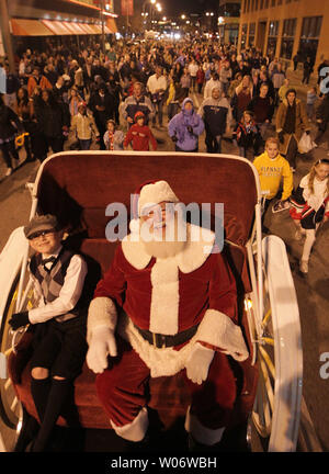 On a horse drawn carriage, Santa Clause leads hundreds throught the streets of St. Louis to look at department store window displays following the annual Christmas Tree lighting ceremony in St. Louis on November 19, 2010. UPI/Bill Greenblatt Stock Photo