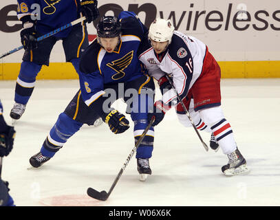 Columbus Blue Jackets Derick Brassard (R) tries to guide the puck while holding the stick of St. Louis Blues Erik Johnson in the third period at the Scottrade Center in St. Louis on January 22, 2011. Columbus won the game 5-2. UPI/Bill Greenblatt Stock Photo