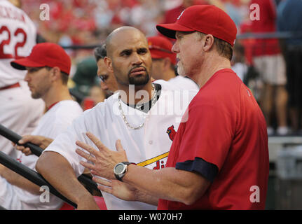 St. Louis Cardinals hitting coach Mark McGwire (R) gives first baseman Albert Pujols some tips during a game against the Colorado Rockies at Busch Stadium in St. Louis on August 13, 2011.     UPI/Bill Greenblatt Stock Photo