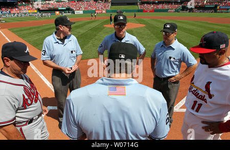 Home plate umpire Chris Guccione checks the lineups before the Atlanta Braves - St. Louis Cardinals baseball game at Busch Stadium in St. Louis on September 11, 2011.  Umpires, coaches and players are all wearing American flag decals on their backs to remember the attacks of September 11, 2001. UPI/Bill Greenblatt Stock Photo