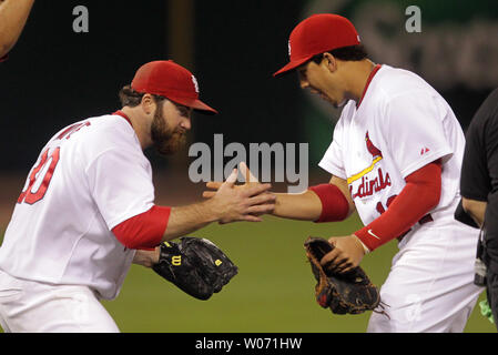 St. Louis Cardinals Jason Motte (L is jumped on by catcher Yadier Molina as  the Cardinals celebrate winning game 7 of the World Series at Busch Stadium  on October 28, 2011 in