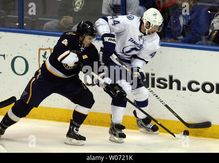 Newly acquired St. Louis Blues Kris Russell (L) takes the puck away from Tampa Bay Lightning Nate Thompson in the first period at the Scottrade Center in St. Louis on November 12, 2011.    UPI/Bill Greenblatt Stock Photo